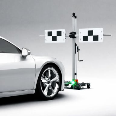 Advanced vehicle alignment technology with a grey car and alignment machine