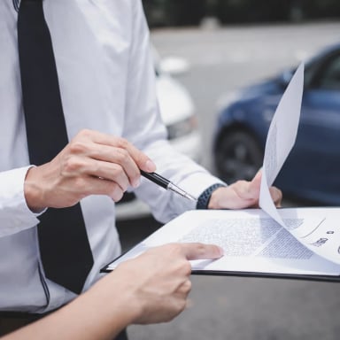 Business professionals reviewing documents outdoors
